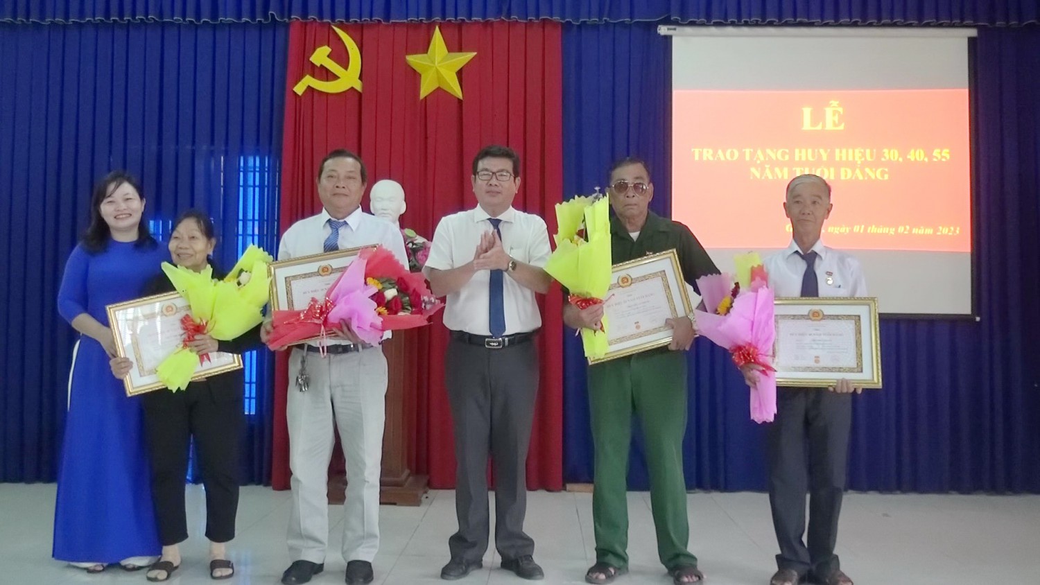 Ông Hồ Văn Hồng- Phó Bí thư Thường trực Thị uỷ, Chủ tịch HĐND thị xã tặng hoa, trao Huy hiệu Đảng cho các đảng viên.